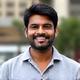 Portrait of Ravi Kumar, a delivery driver, smiling confidently.